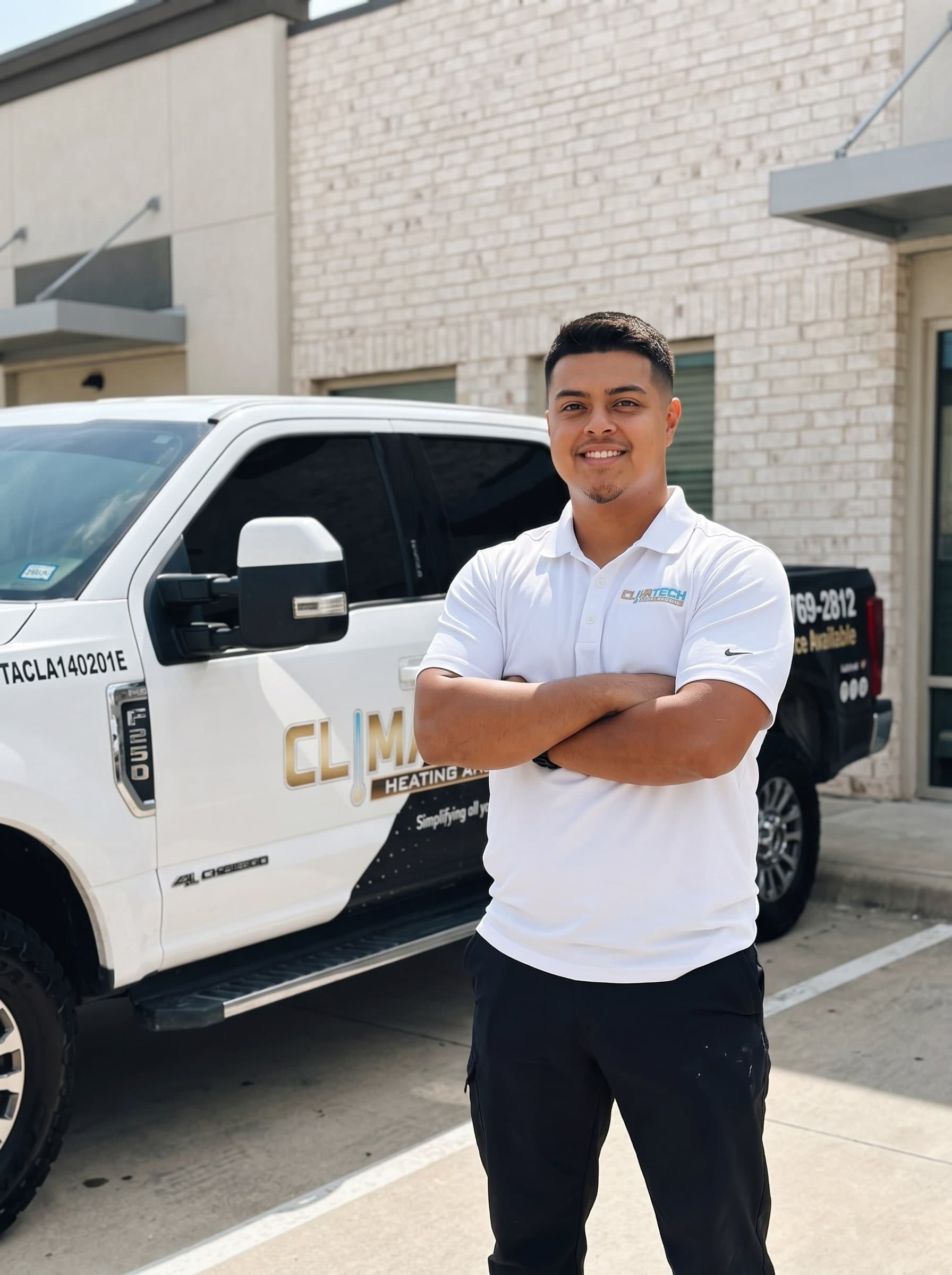 Alex, the owner of Climatech Heating and Air, standing in front of the wrapped F-250 service truck in Mesquite, Texas